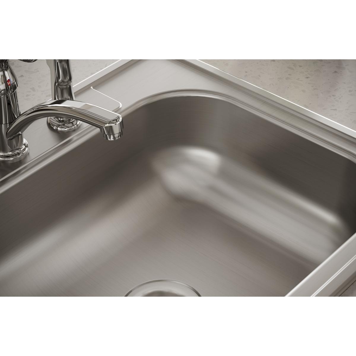 Stainless steel single bowl drop-in sink with two faucet holes and chrome faucet installed.