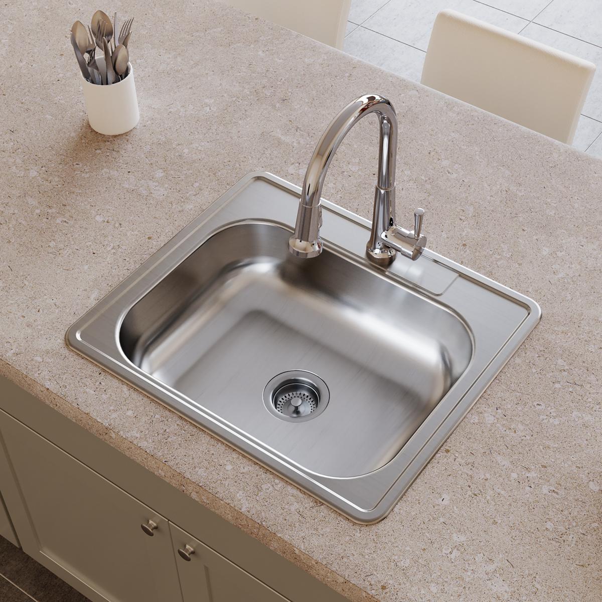 Stainless steel drop-in sink with single bowl, drain, and four-hole faucet mounting installed in countertop.