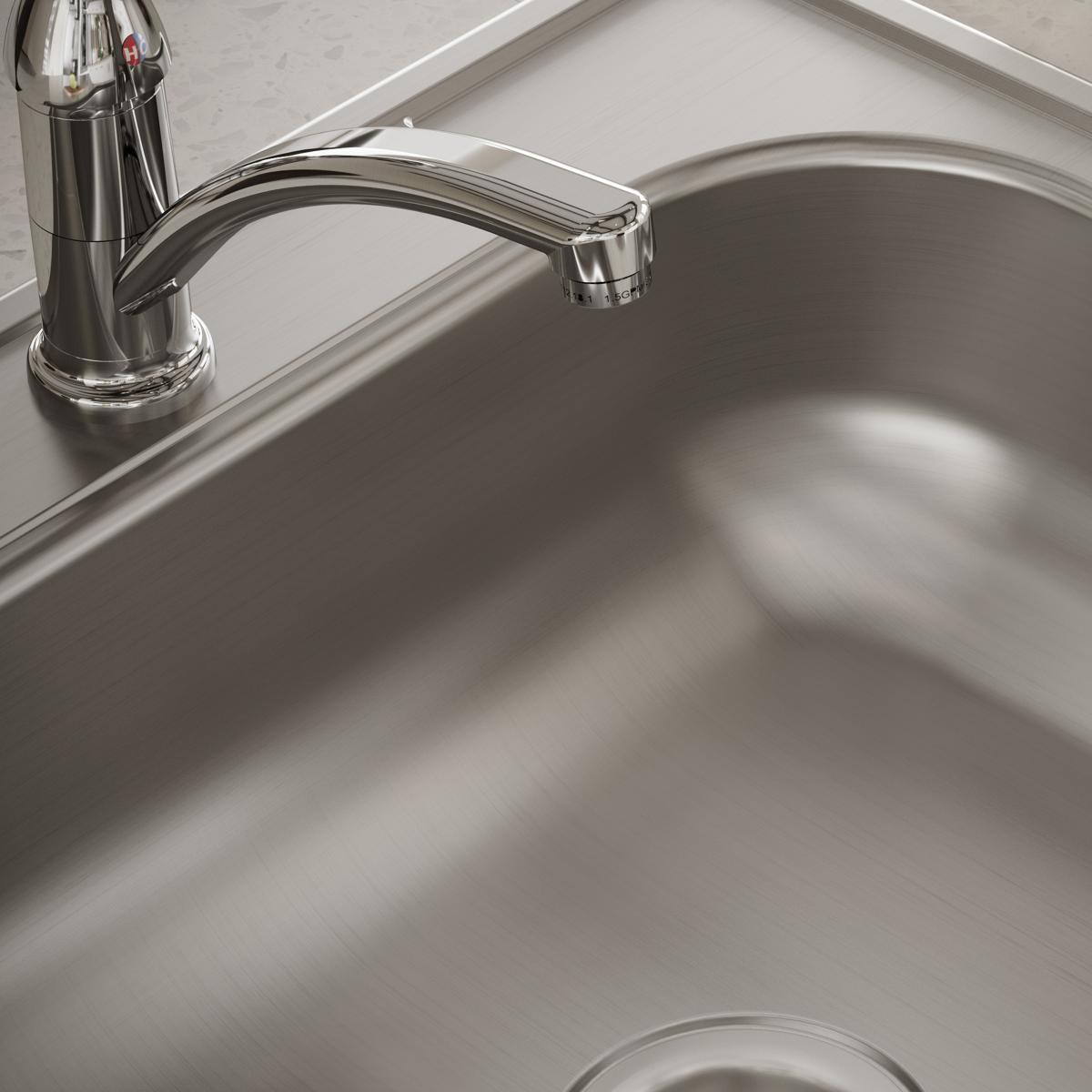 Stainless steel drop-in sink with single bowl and chrome faucet installed in countertop.