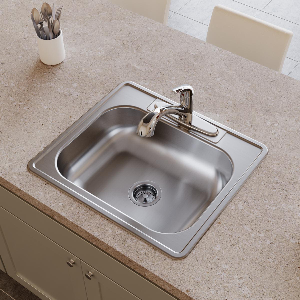 Stainless steel drop-in sink with single bowl, drain, and chrome faucet mounted on countertop.