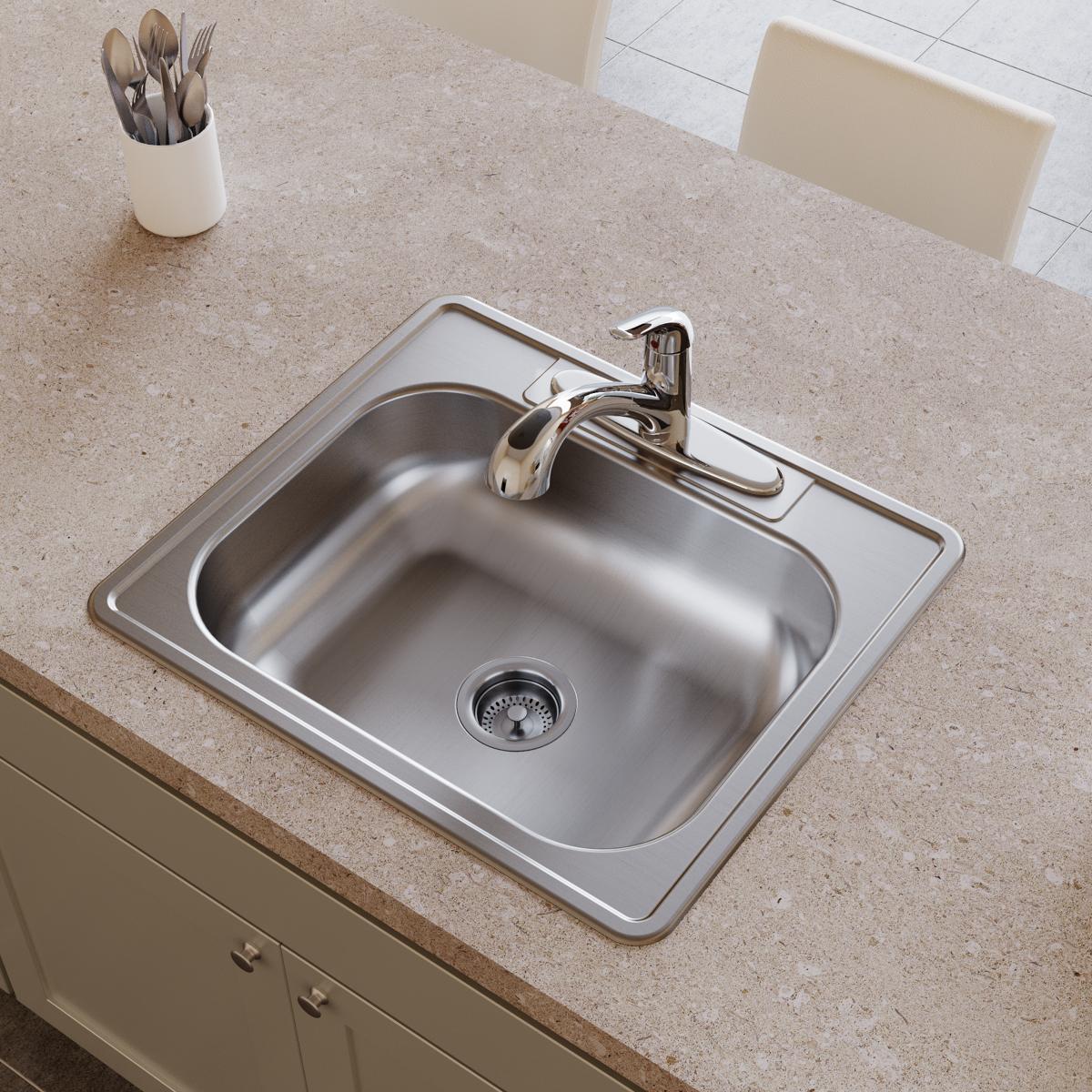 Stainless steel single bowl drop-in sink with faucet and drain strainer installed in beige countertop.
