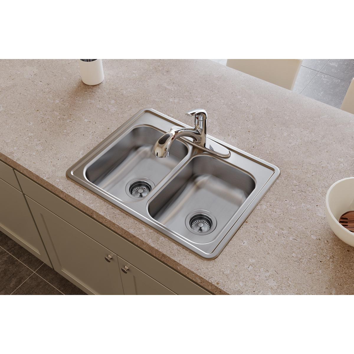 Stainless steel double bowl drop-in sink with two drain strainers installed in countertop with single faucet.