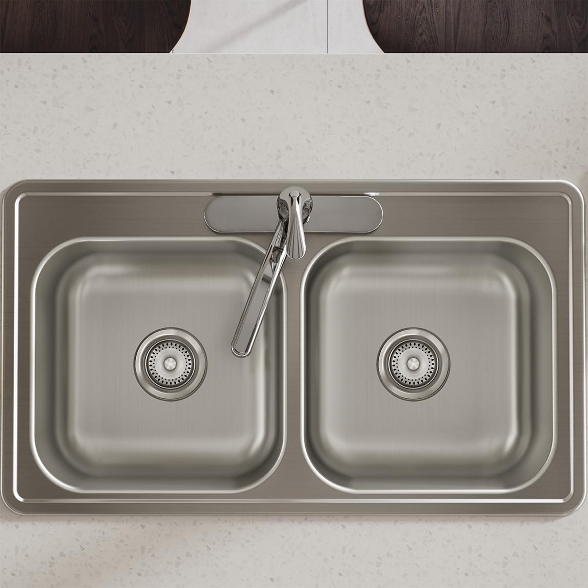 Stainless steel drop-in sink with two equal bowls, drain strainers, and faucet holes, viewed from above.