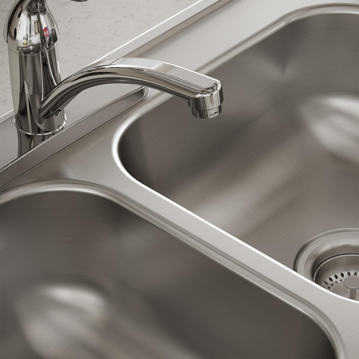 Stainless steel double bowl drop-in sink with chrome faucet and three mounting holes.