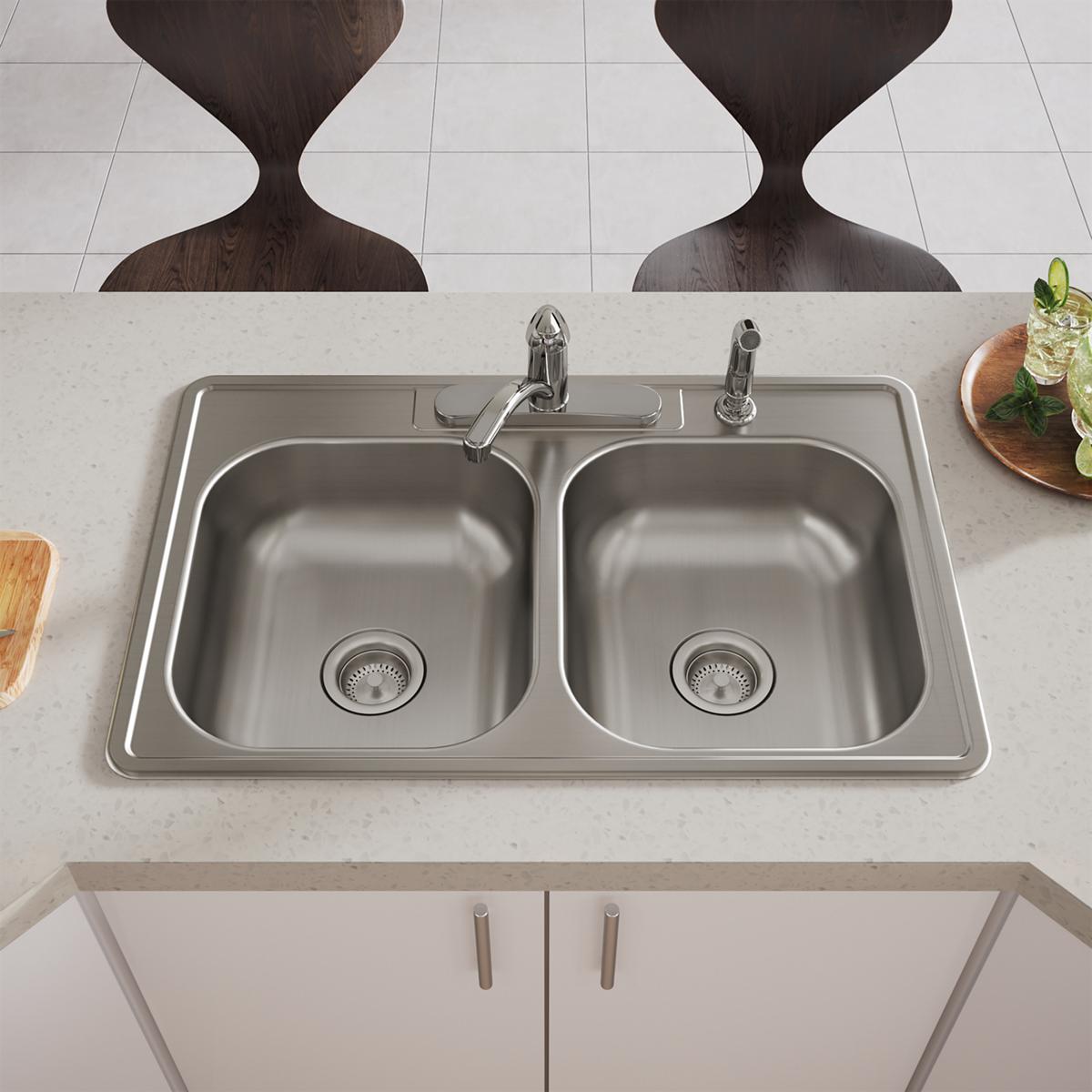 Stainless steel drop-in sink with two equal bowls, four holes, and dual faucet mounted on countertop.