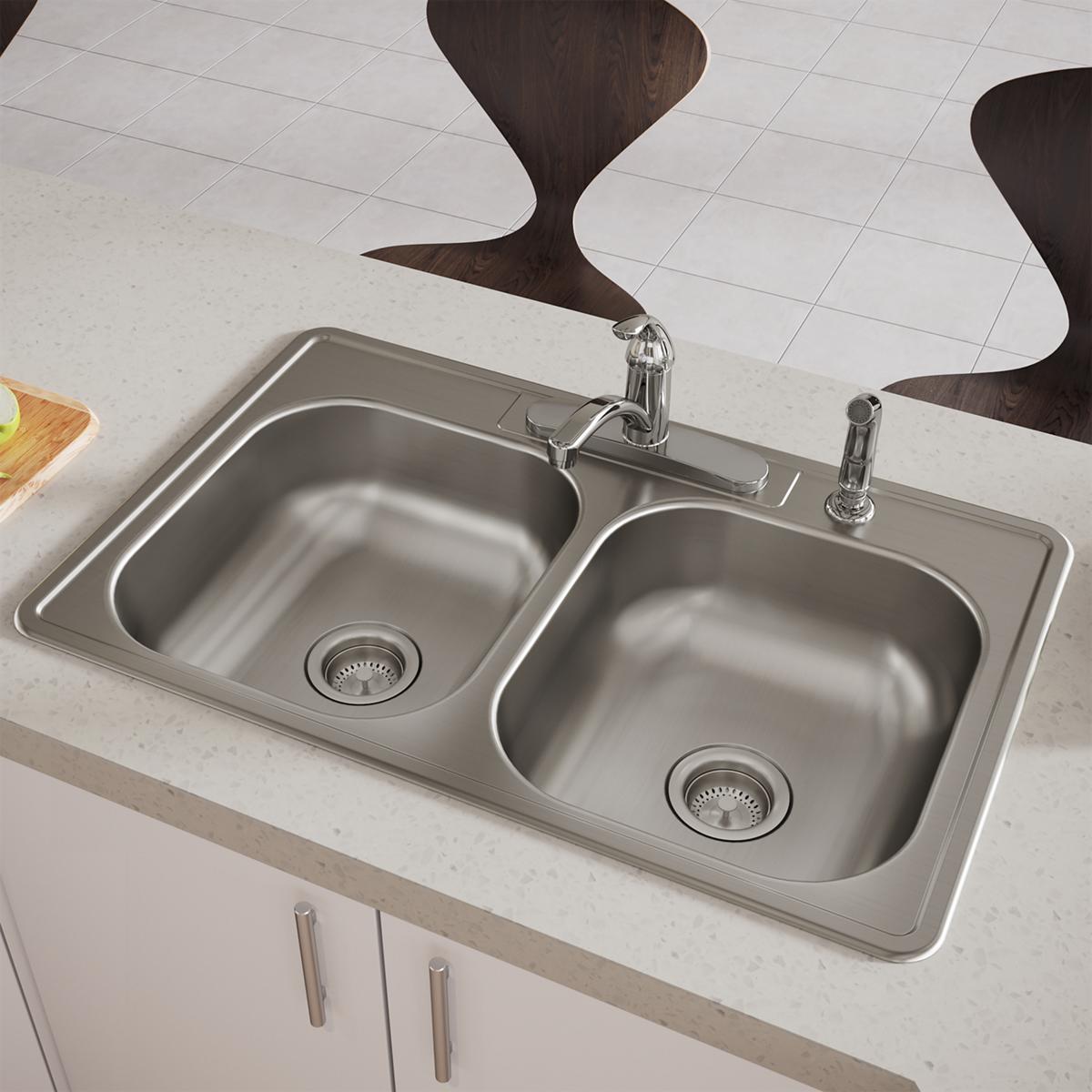 Stainless steel drop-in sink with two equal bowls, four mounting holes, and dual chrome faucets installed in white countertop