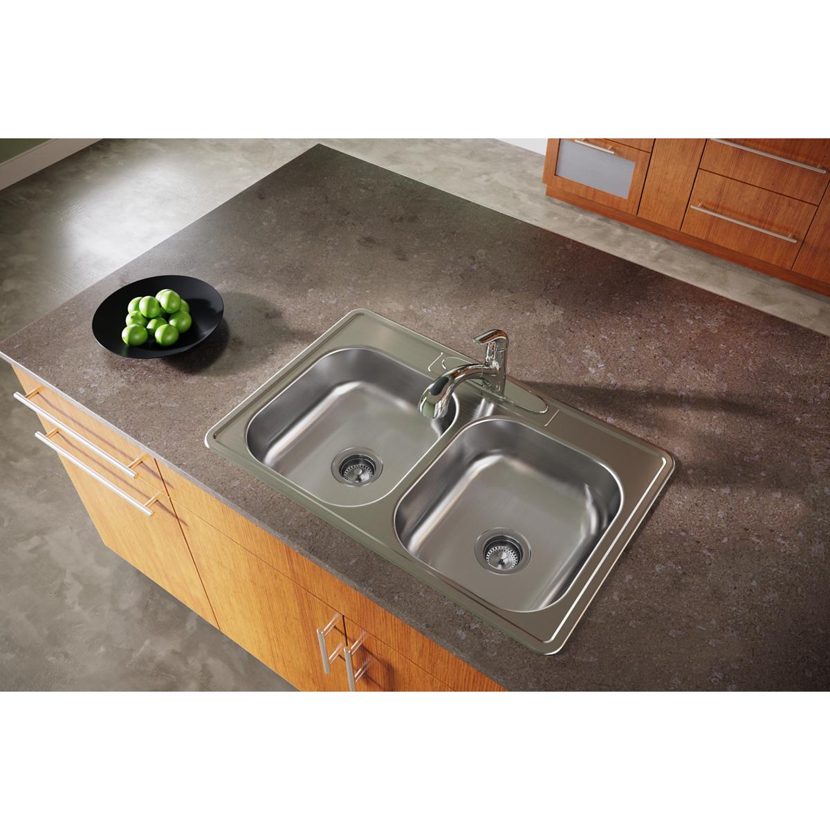 Stainless steel double bowl drop-in sink with two equal basins and chrome faucet installed in countertop.