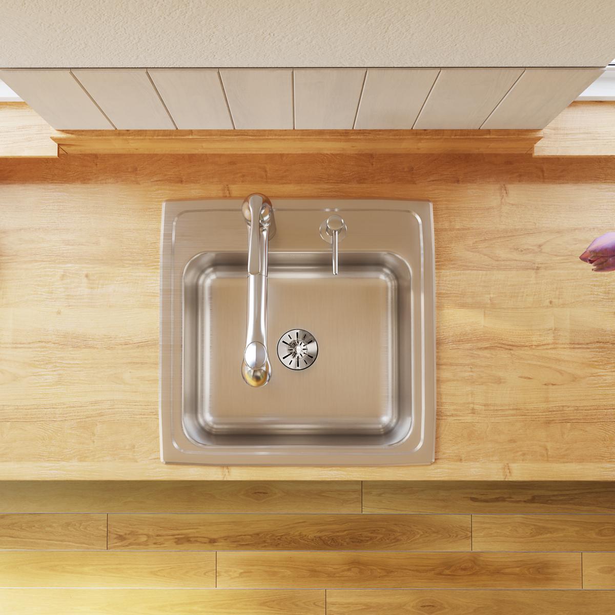Stainless steel drop-in laundry sink with single basin, three holes, and drain visible from above on wood countertop.