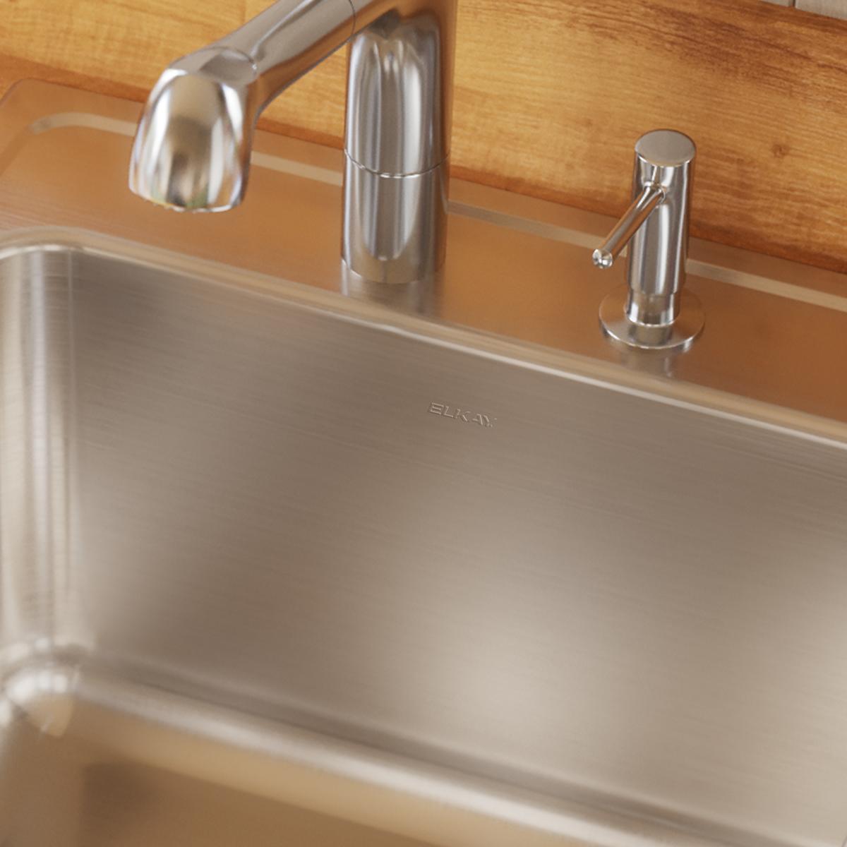 Stainless steel drop-in sink with single bowl, brushed finish, and three-hole faucet mounting installed in wood countertop.