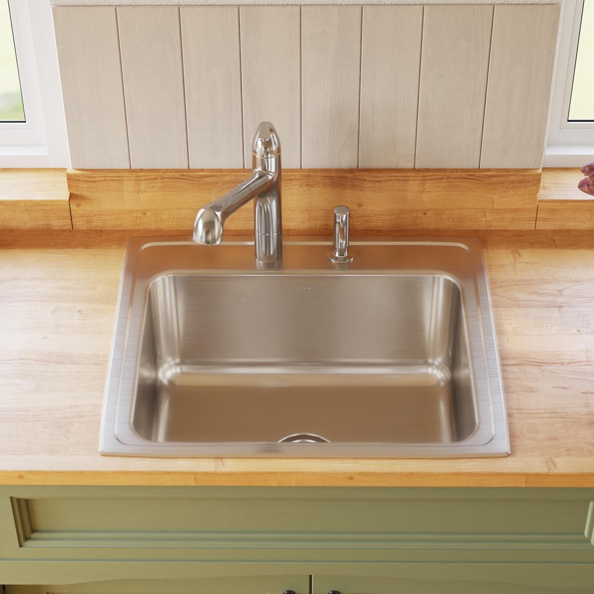 Stainless steel drop-in sink with single bowl and one faucet hole, installed in wooden countertop with chrome faucet.