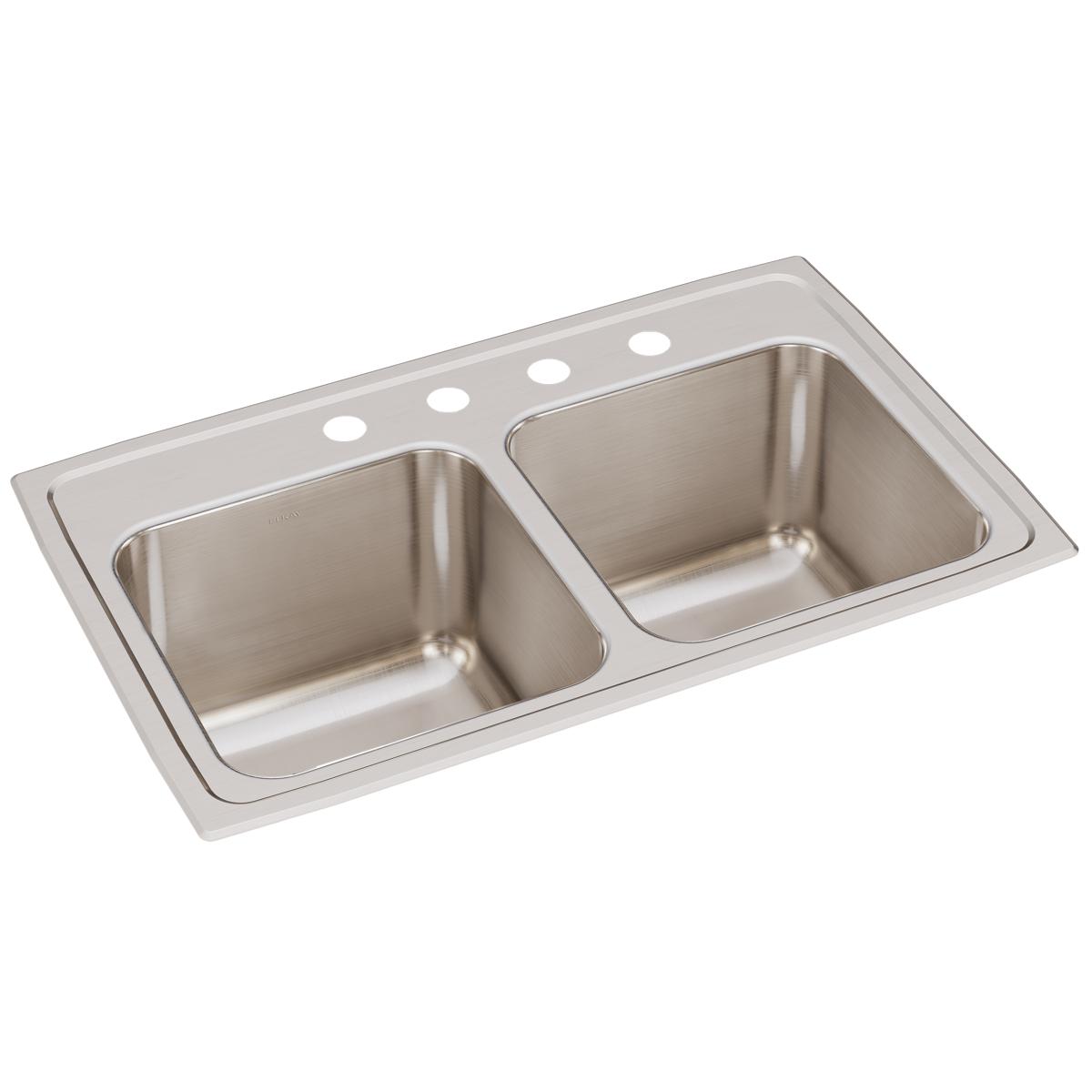 Stainless steel double bowl drop-in sink with four faucet holes across the rim.