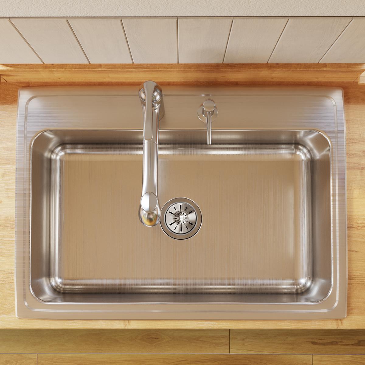 Stainless steel rectangular drop-in sink with single bowl and faucet hole, mounted in wooden countertop.
