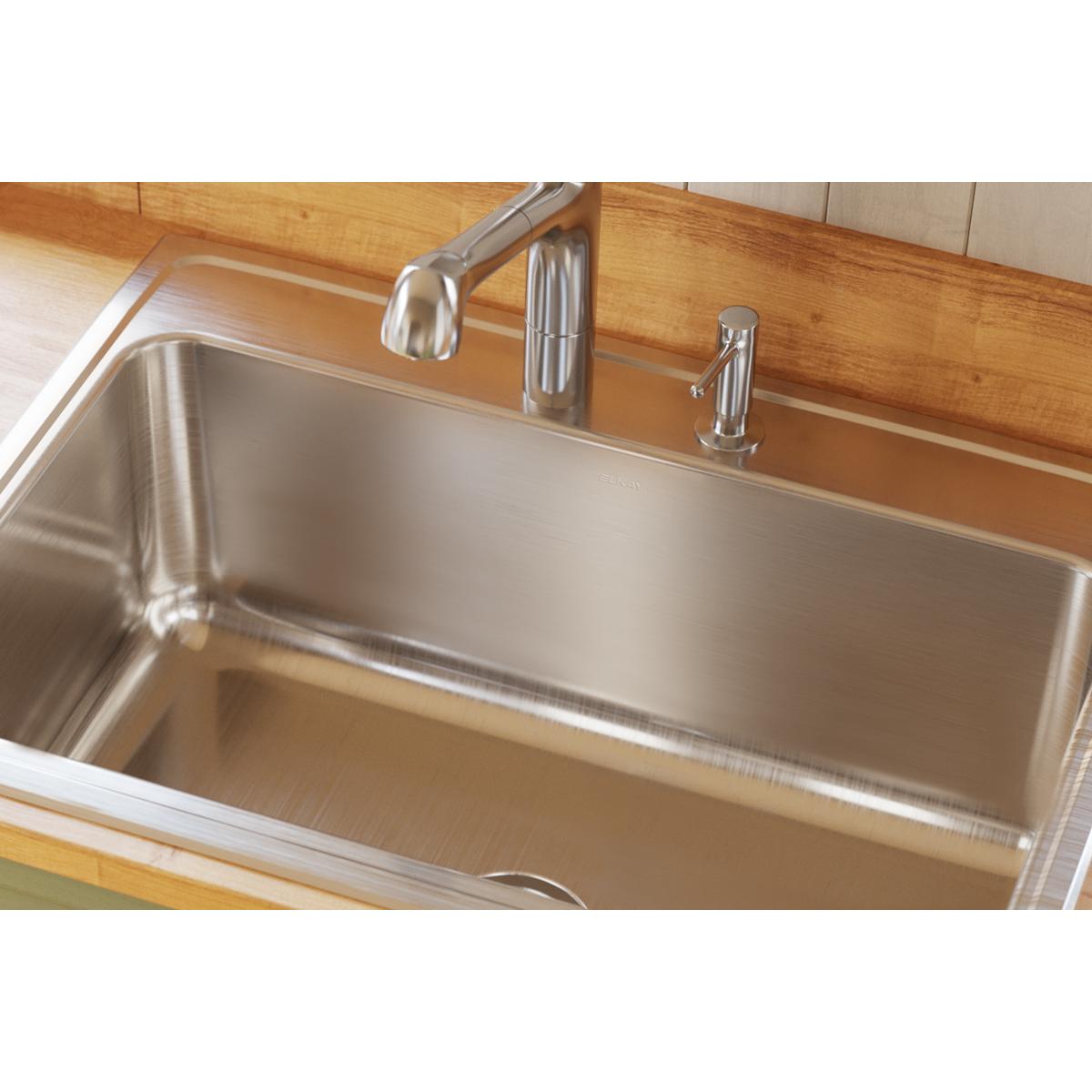 Stainless steel drop-in sink with single bowl and five mounting holes, installed in wood countertop with chrome faucet.