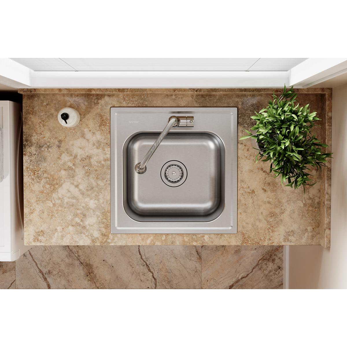 Stainless steel square laundry sink with single bowl and sprayer faucet installed in countertop, overhead view.