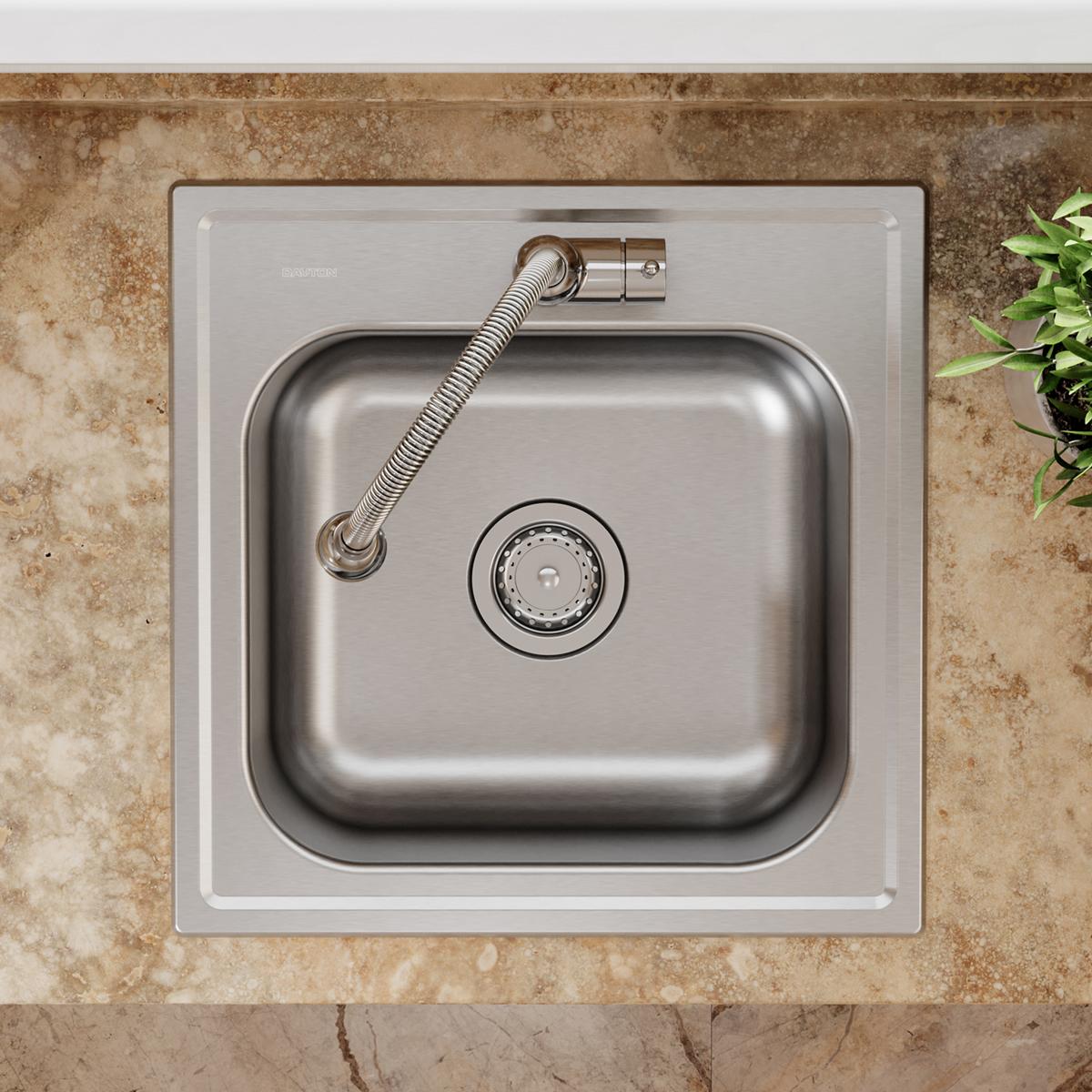 Stainless steel sink basin with circular drain basket strainer and flexible metal hose connection mounted on countertop.