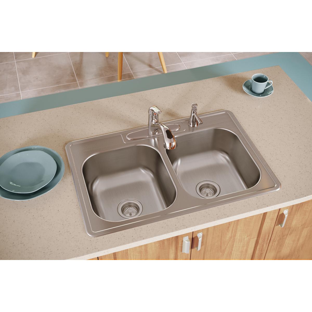 Stainless steel drop-in sink with two equal bowls and single faucet hole installed in countertop.