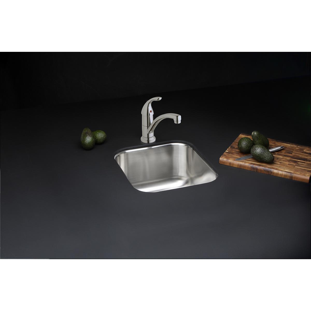 Chrome single-hole kitchen faucet with lever handle mounted above stainless steel sink.