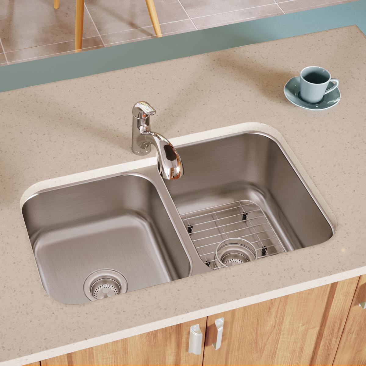 Stainless steel bottom grid with horizontal wires positioned in kitchen sink basin.
