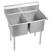 Stainless steel two-compartment sink with backsplash and four legs, viewed from above at an angle.