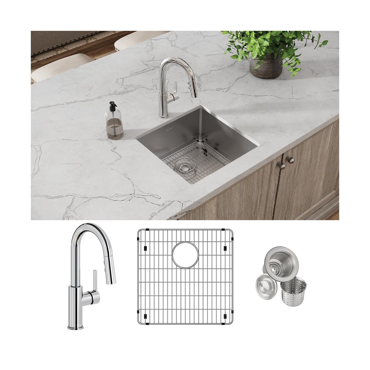 Stainless steel undermount kitchen sink with chrome pull-down faucet, bottom grid, and drain strainer installed in white marb