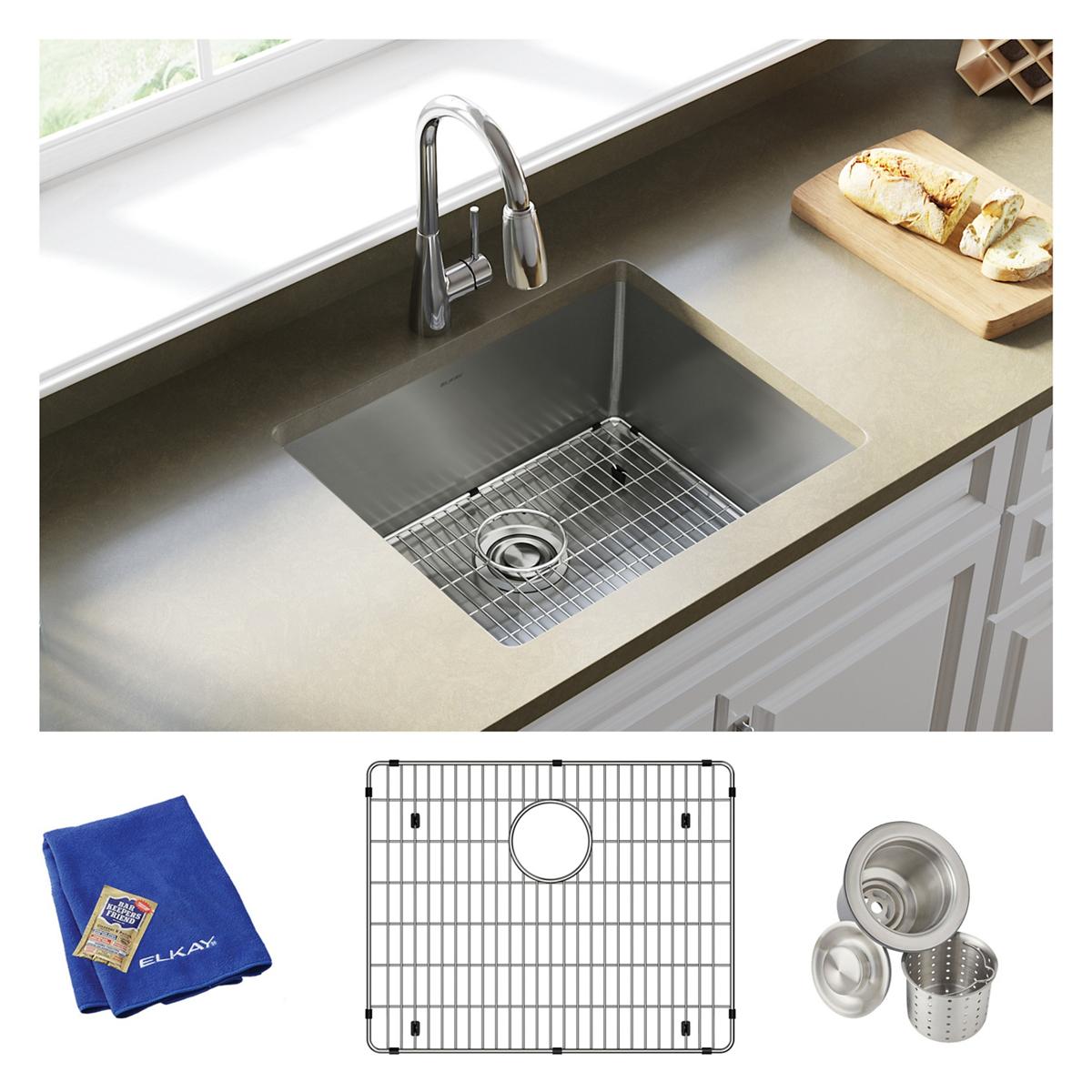 Stainless steel undermount kitchen sink with pull-down faucet, sink grid, strainer basket, and blue cloth included.