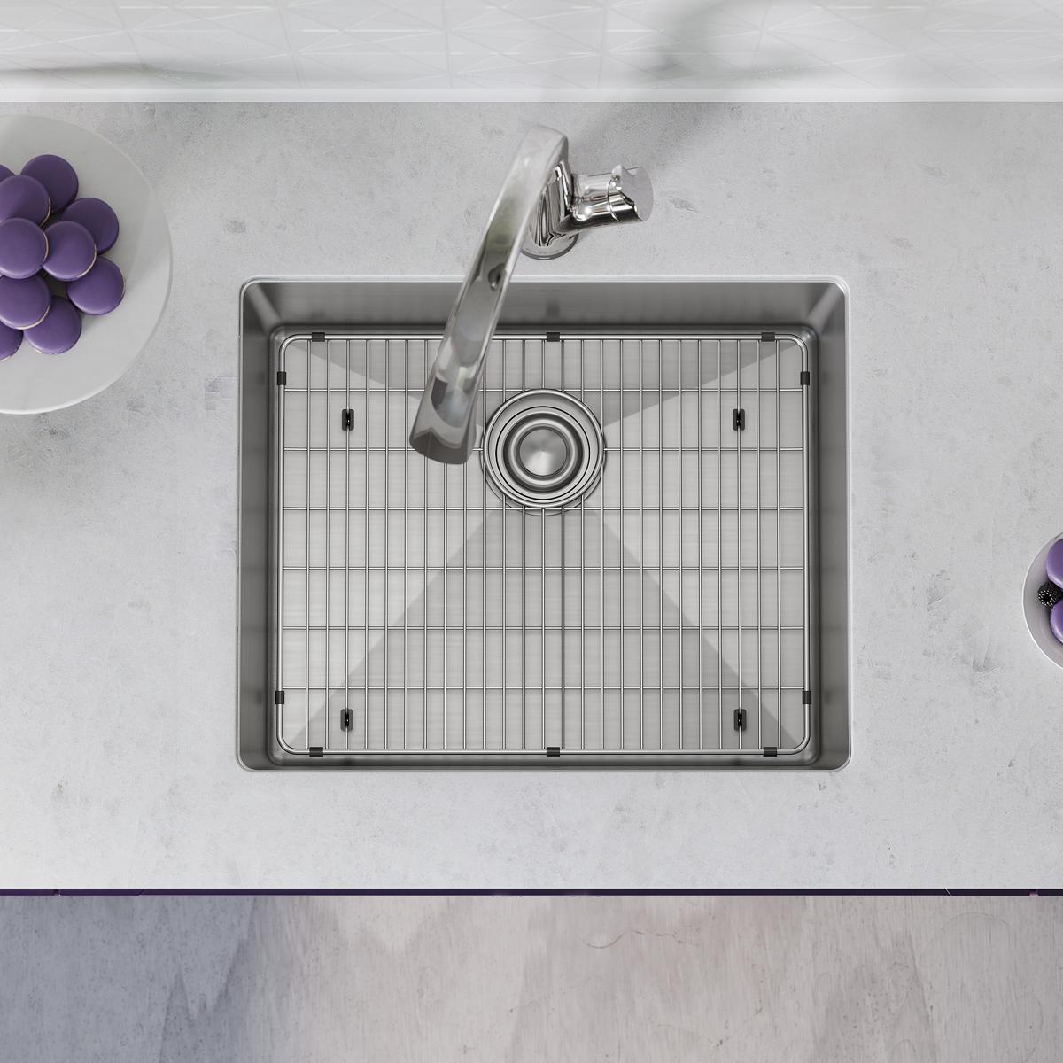 Stainless steel rectangular single bowl undermount sink with integrated drain and grid strainer, paired with arched filtered 