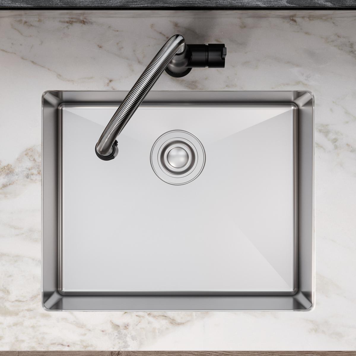 Stainless steel single bowl undermount sink with drain and curved faucet, viewed from above on marble countertop.