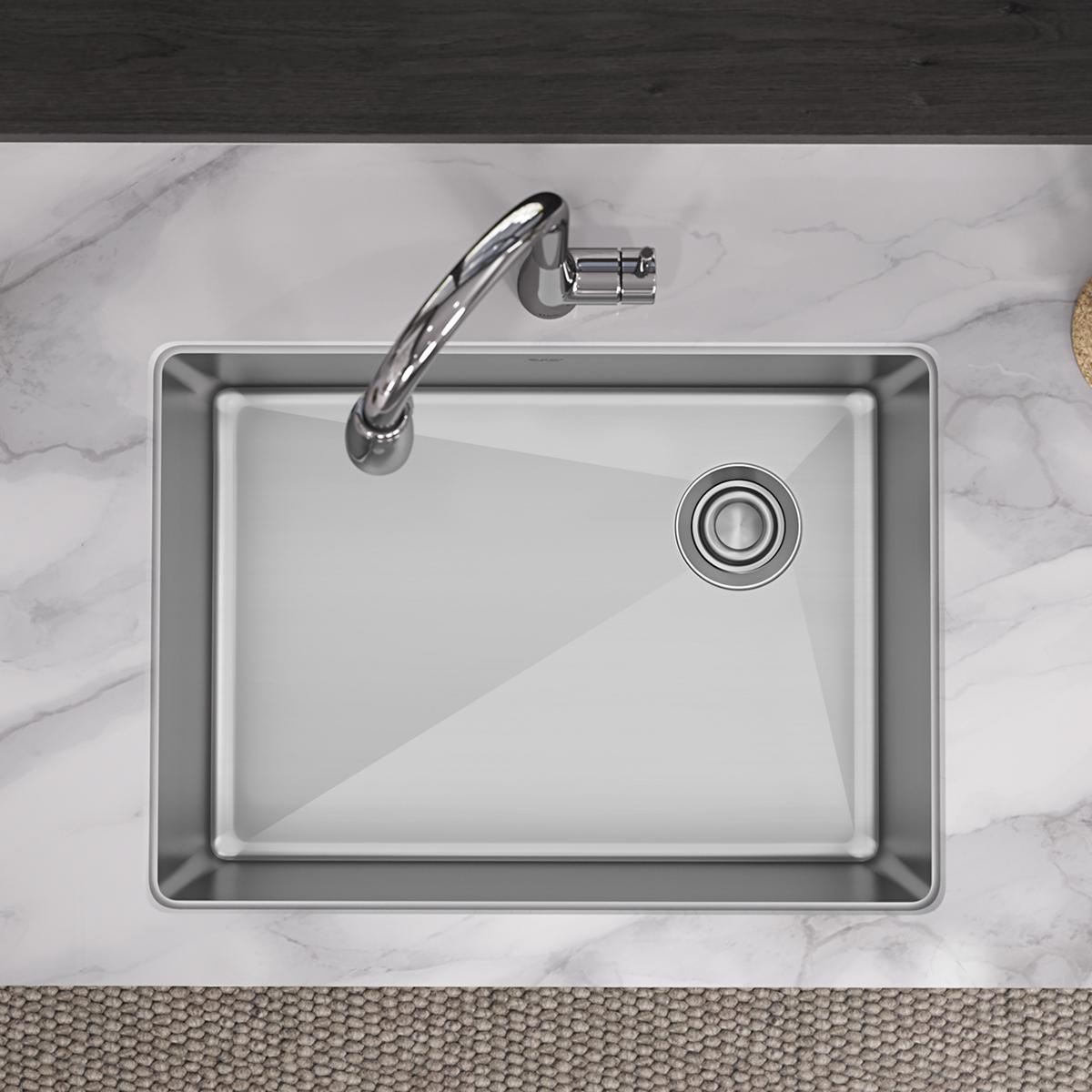 Stainless steel single bowl undermount sink with rounded corners and drain strainer, shown from above installed in marble cou