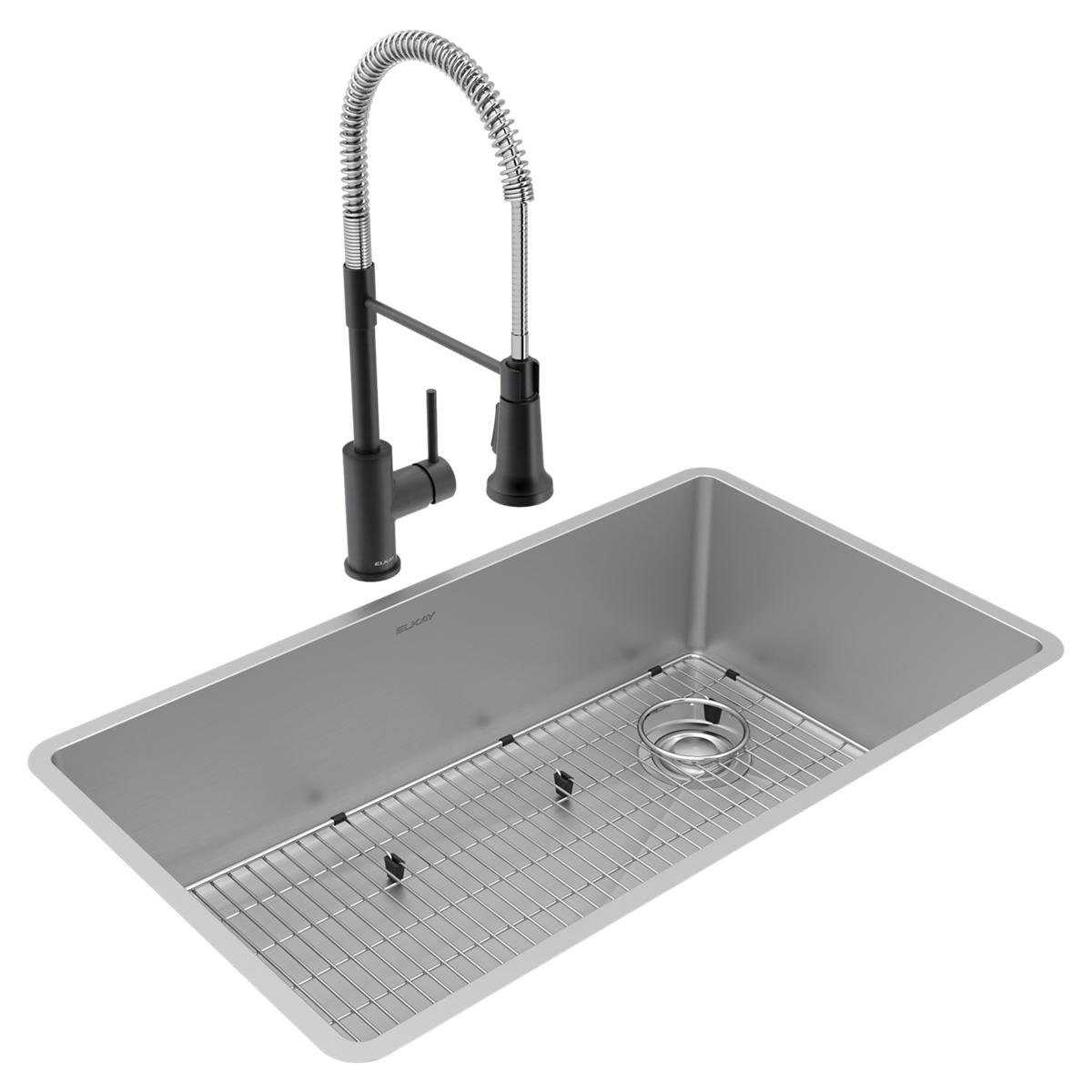 Stainless steel single bowl undermount sink with grid and drain, paired with black pull-down faucet.