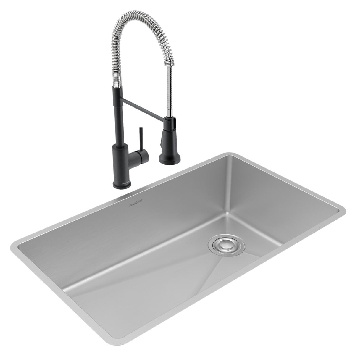 Stainless steel undermount sink with single bowl and black pull-down faucet with coiled spray hose.
