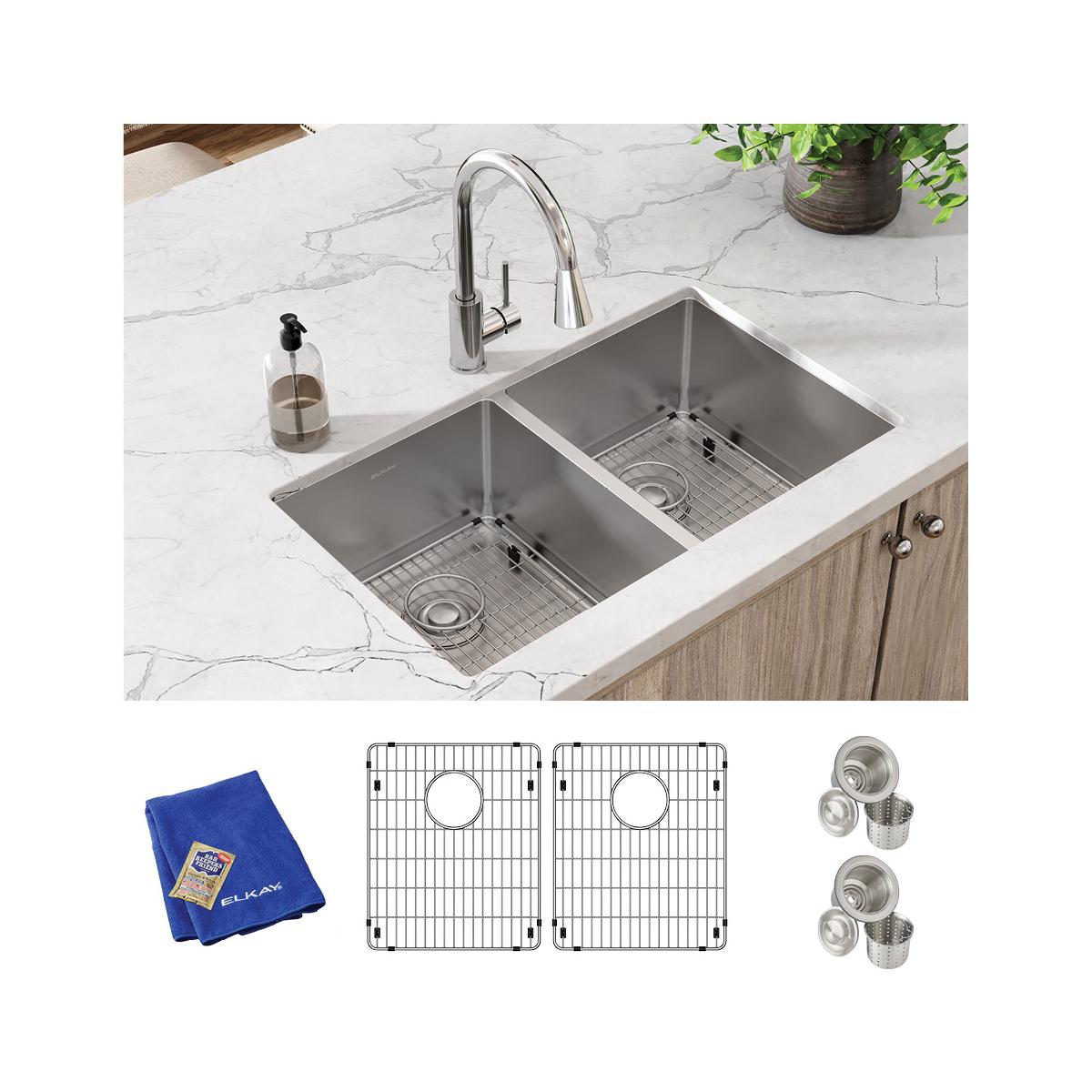 Stainless steel double bowl undermount sink with two grid strainers, blue cloth, and accessories installed in marble countert