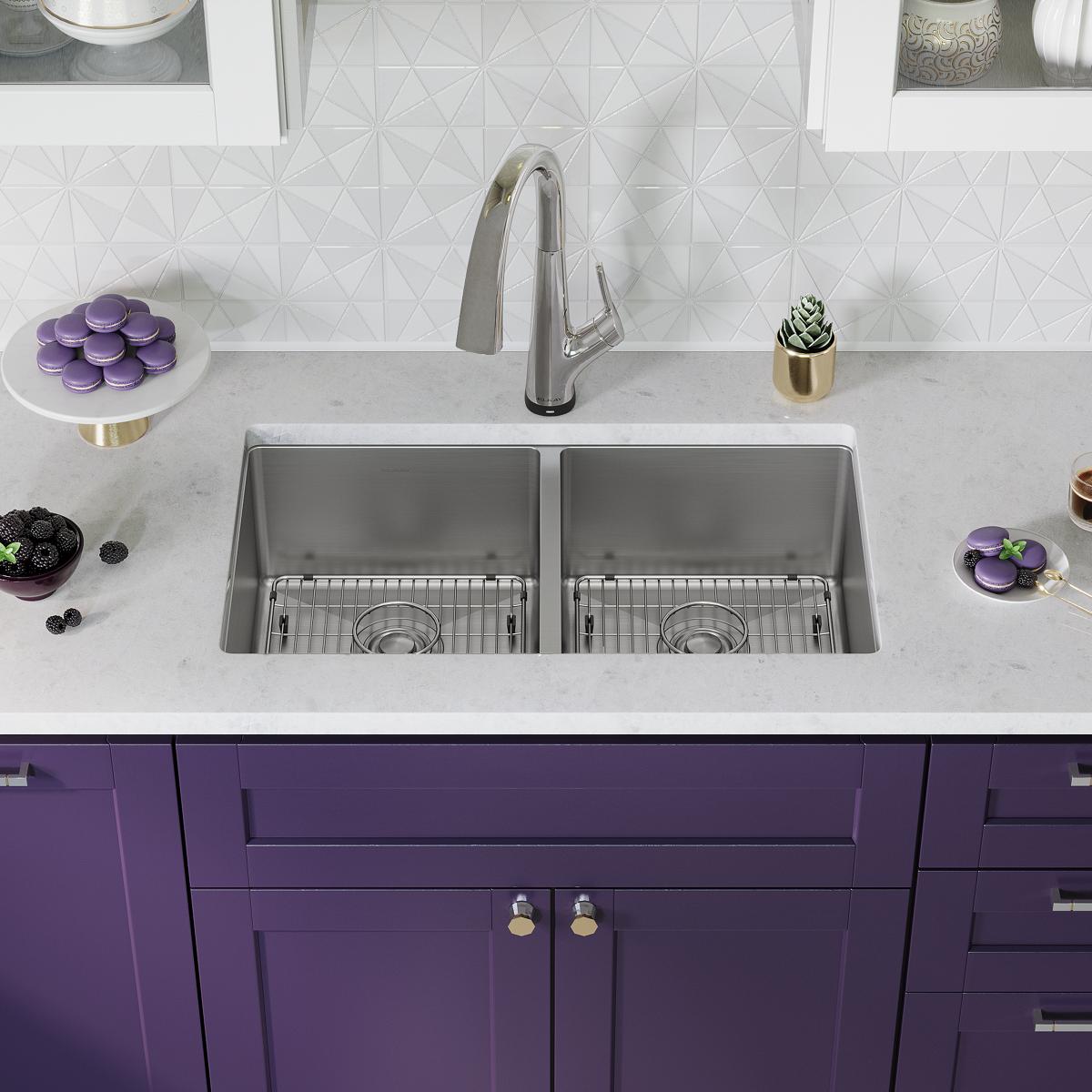 Stainless steel double bowl undermount sink with chrome filtered faucet installed in white countertop with geometric backtile