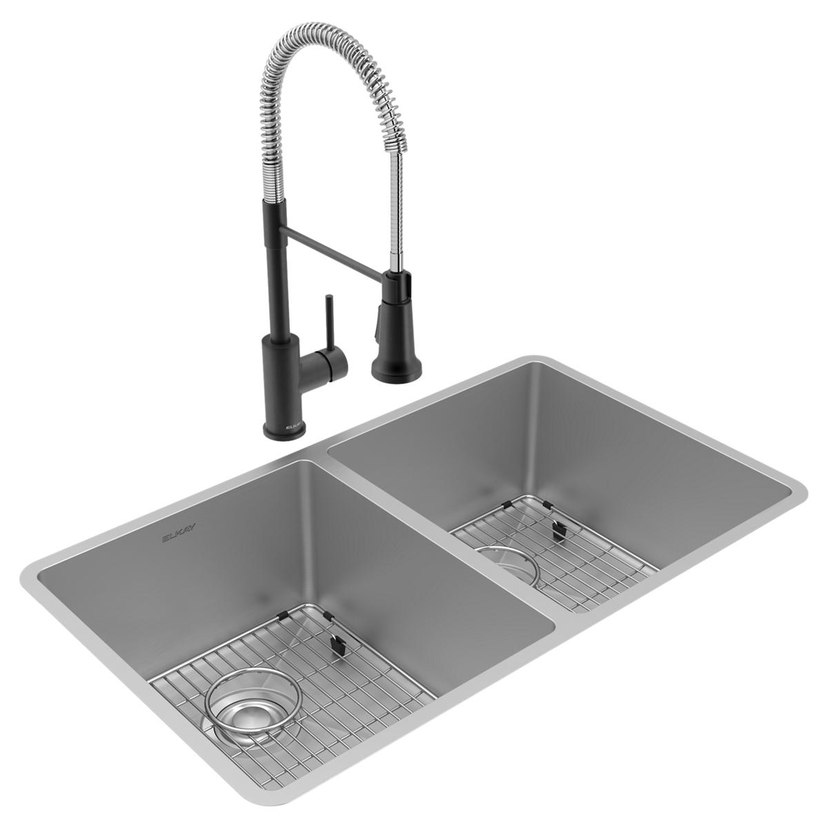 Stainless steel double bowl undermount sink with two grid inserts, drains, and black pull-down faucet with spray head.