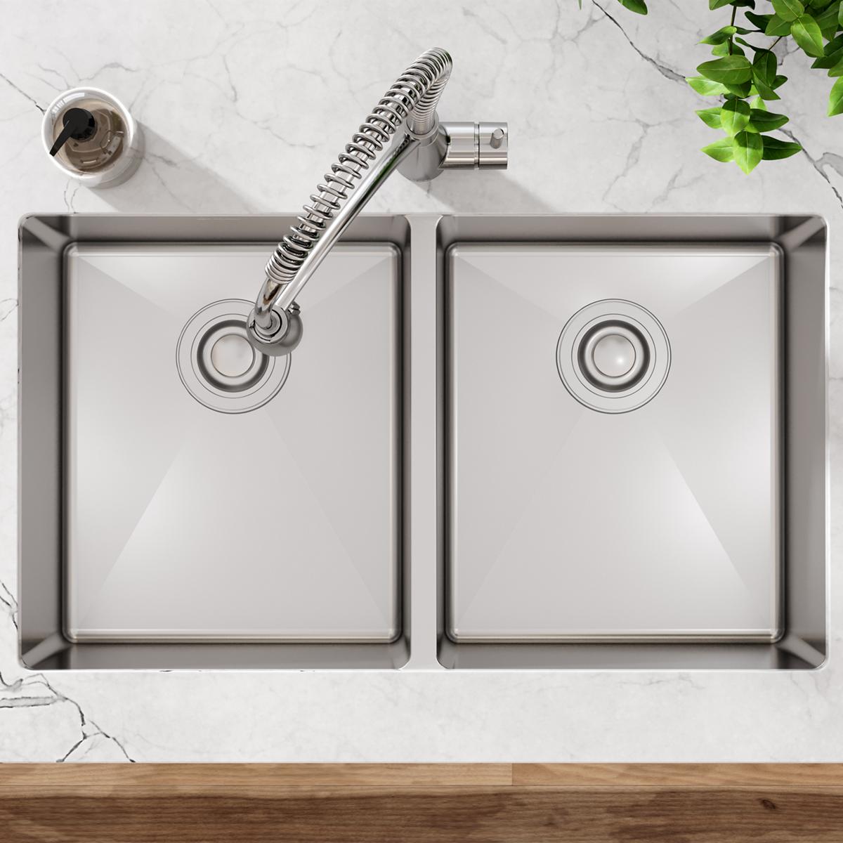 Stainless steel double bowl undermount sink with two equal basins and spiral pull-down faucet, installed in marble countertop