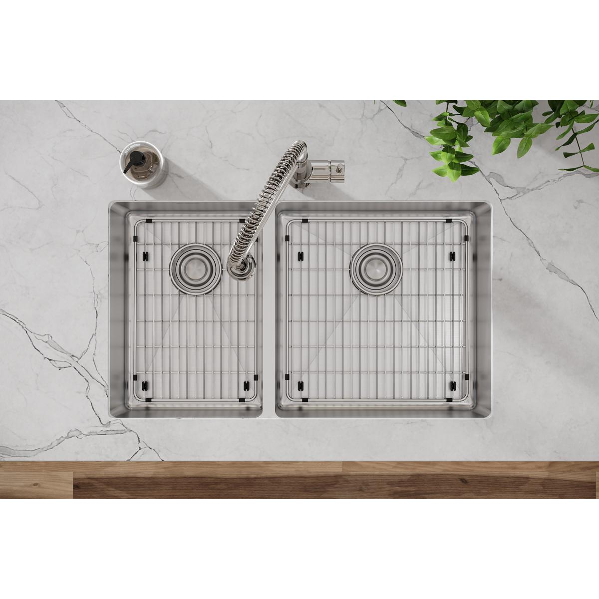 Stainless steel sink bottom grid with vertical ribbed pattern and corner mounting posts.