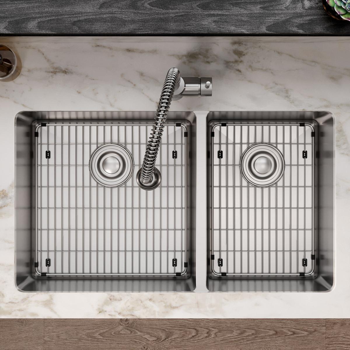 Stainless steel double bowl undermount sink with two equal compartments, each with a grid strainer and drain, installed in ma
