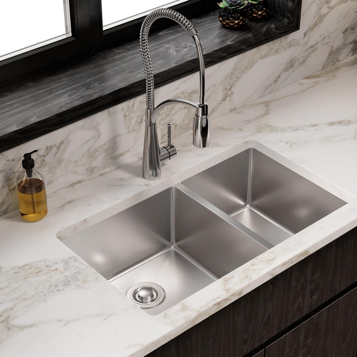 Stainless steel double bowl undermount sink installed in marble countertop with chrome pull-down faucet.