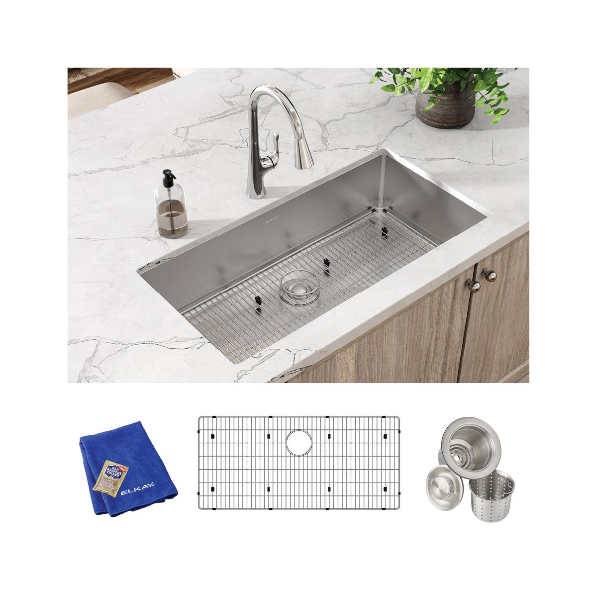 Stainless steel undermount sink with grid, strainer basket, and microfiber cloth included in kit.