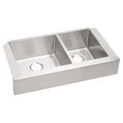 Stainless steel double bowl farmhouse sink with unequal sized bowls and drain holes.