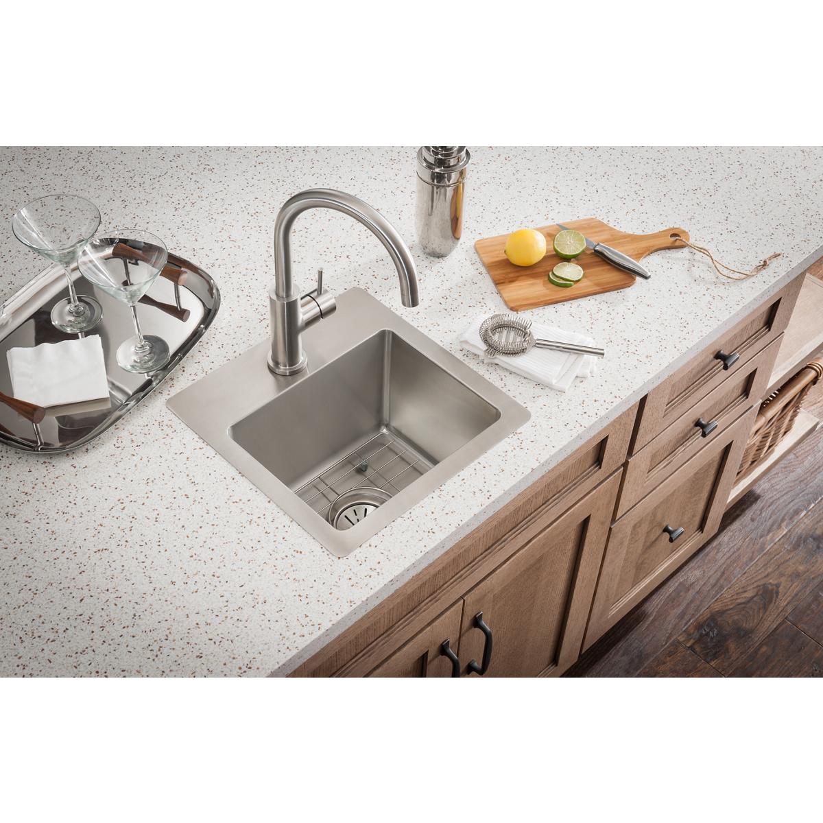 Satin stainless steel single-hole kitchen faucet with curved spout and lever handle mounted above undermount sink.