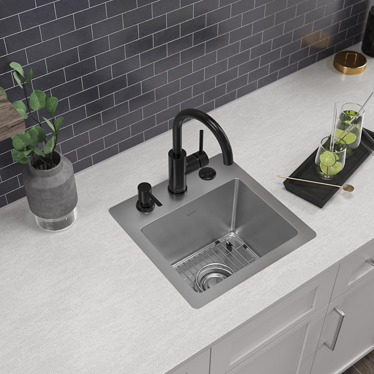 Stainless steel square bar sink with single bowl, three-hole mounting, black faucet, and drain basket installed in white coun