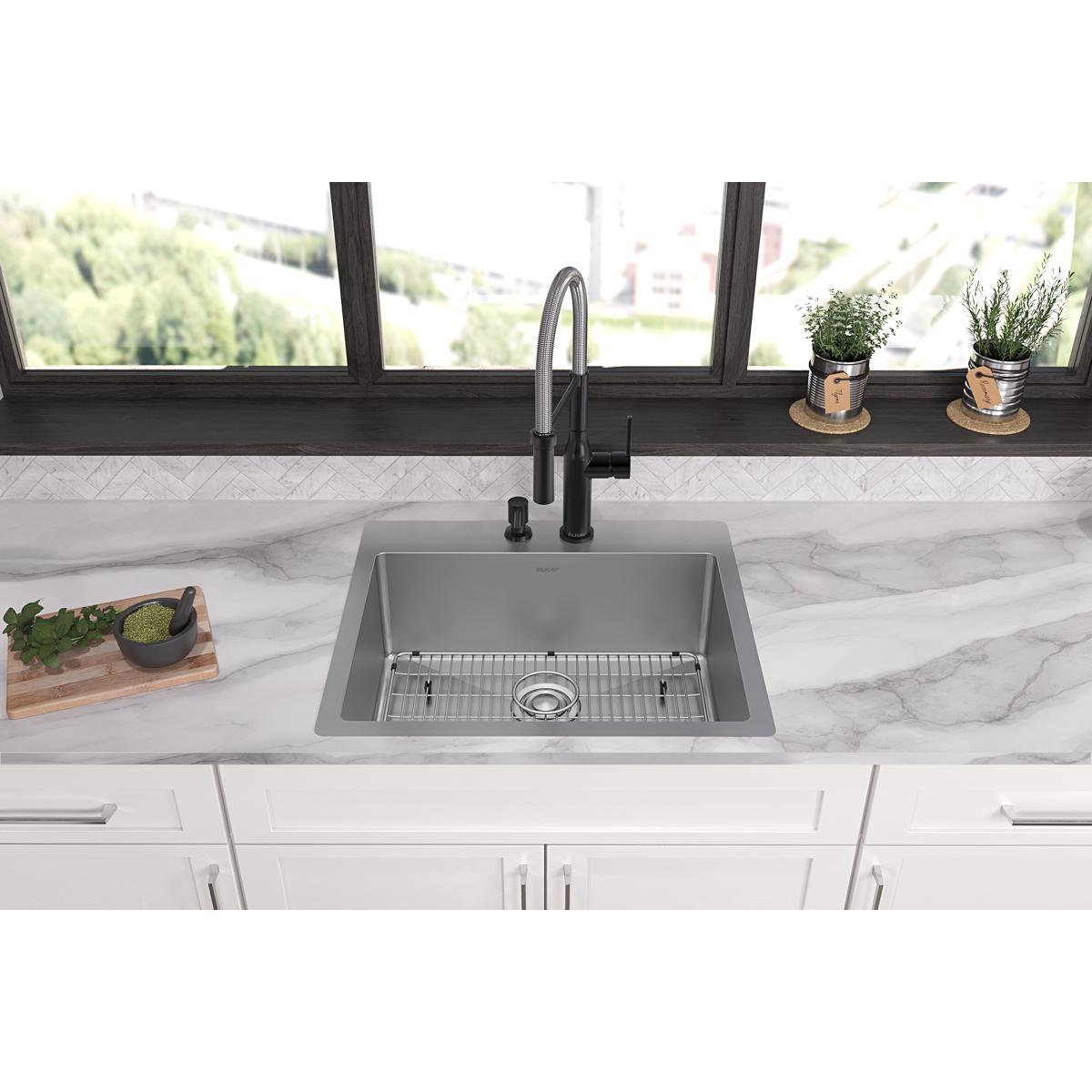 Stainless steel single bowl sink with two faucet holes, grid strainer, and black pull-down faucet installed in marble counter