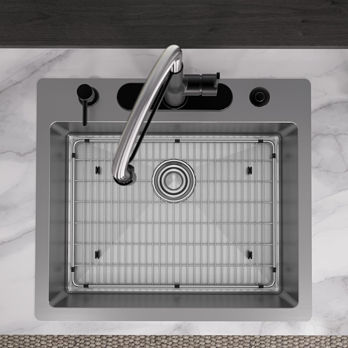 Stainless steel single bowl sink with faucet and grid insert, viewed from above on marble countertop.