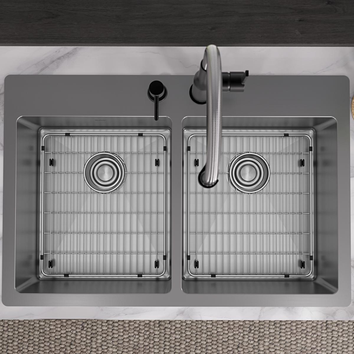 Stainless steel double bowl sink with two equal-sized basins, grid inserts, and chrome faucet mounted on countertop.