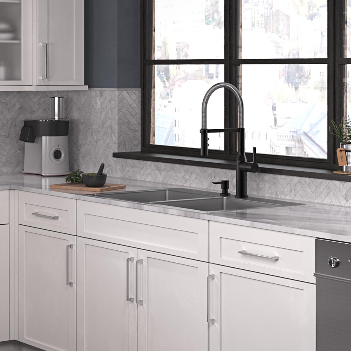 Stainless steel double bowl sink with two equal-sized basins and two faucet holes, mounted in white cabinetry with black fauc