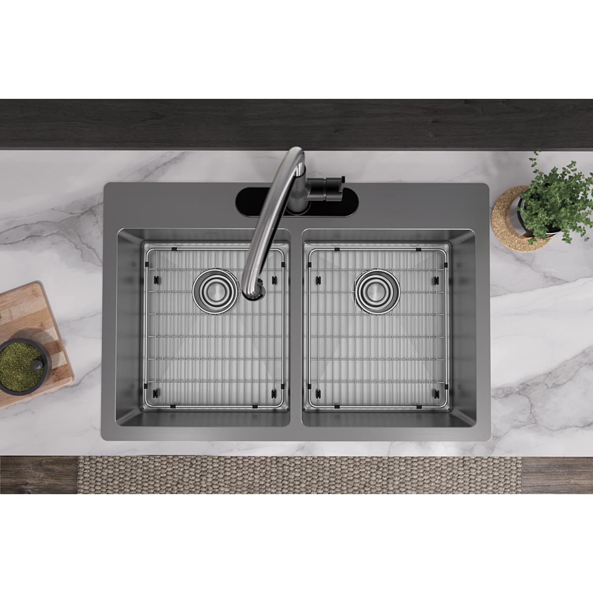 Stainless steel double bowl sink with two equal basins, grid inserts, and single faucet mounted on marble countertop.