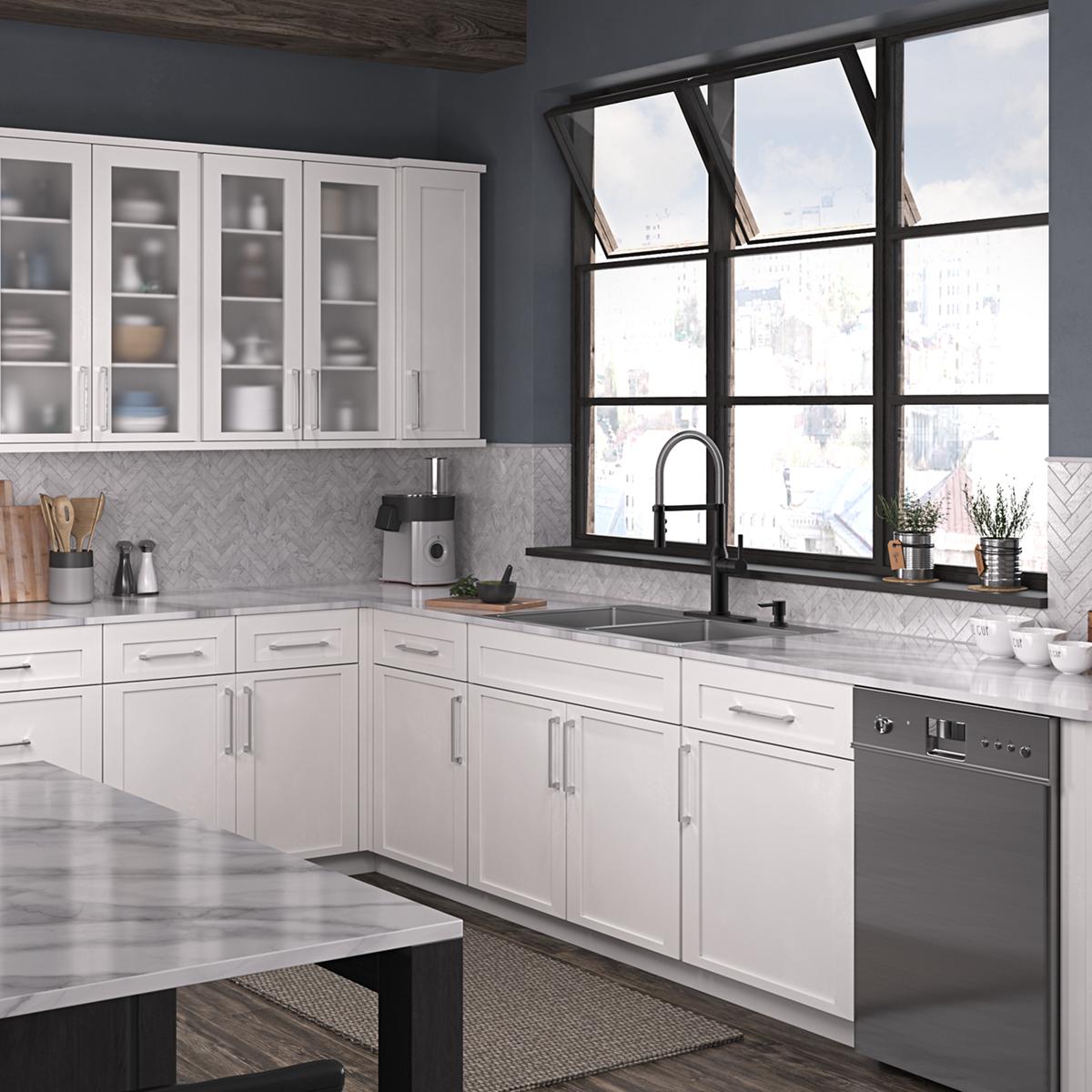 Stainless steel double bowl sink with two equal compartments installed in white kitchen cabinetry beneath black faucet.