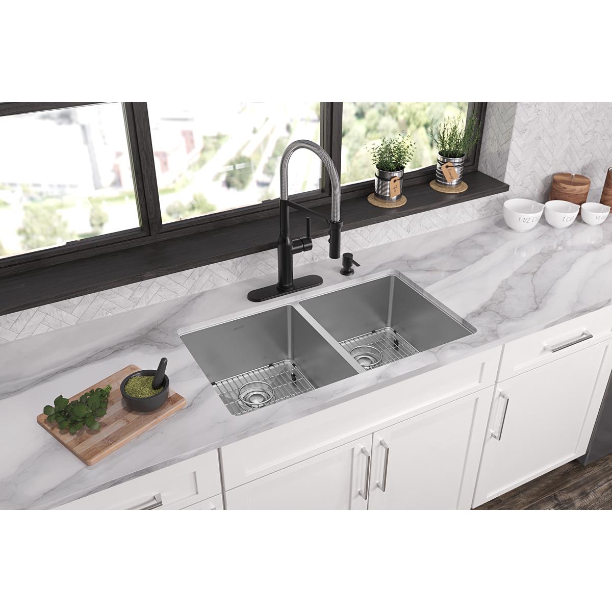 Stainless steel double bowl sink with two equal compartments and four mounting holes installed in white kitchen countertop.
