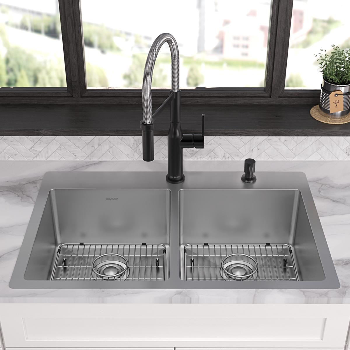 Stainless steel double bowl sink with two equal compartments, each equipped with a metal grid insert and black pull-down fauc