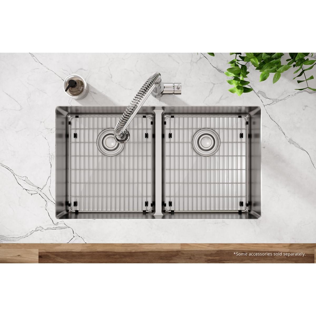 Stainless steel double bowl sink with equal-sized compartments, grid inserts, one faucet hole, and flexible spray faucet.